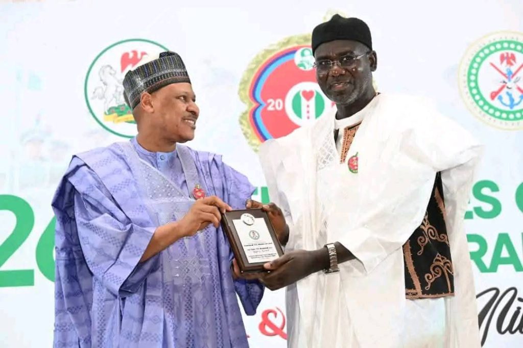 Buratai Takes Centre Stage as FG Honours Army Chiefs, Veterans at AFCRD 2026   Or  AFCRD 2026: FG Recognises Buratai’s Reforms, Sacrifice and National Service    The Federal Government has placed former Chief of Army Staff, Lieutenant General Tukur Yusuf Buratai (rtd), at the heart of the 2026 Armed Forces Celebration and Remembrance Day (AFCRD) honours, recognising his enduring legacy of service, sacrifice and institutional reforms within the Nigerian Army.    Buratai was conferred with the Legacy (Service and Sacrifice) Award at the AFCRD Gala Night held on Tuesday, 13 January 2026, at the Banquet Hall of the State House, Abuja. The award acknowledges his far-reaching reforms between 2015 and 2021, which expanded the Army’s operational capacity, strengthened counter-insurgency architecture, and repositioned the force for modern asymmetric warfare. It also recognises his post-service contribution as Nigeria’s Ambassador to the Republic of Benin.        Alongside Buratai, the Chief of Army Staff, Lieutenant General Waidi Shaibu, received the Service and Sacrifice Award for decisive leadership and selfless service in counter-insurgency and internal security operations across multiple theatres.       Other recipients in the same category include Major General Abdulsalami Enesi Abubakar, Theatre Commander, Operation HADIN KAI, and Major General Faruk Mijinyawa, former General Officer Commanding, 81 Division, Lagos, for exceptional operational leadership and commitment to duty.       The Gallantry Award was presented to Brigadier General Misa Uba for leading troops from the front during counter-insurgency operations in Borno State. Brigadier General Usman Ahmad received the Mission Success Award for repelling repeated terrorist attacks and sustaining operational effectiveness under intense pressure.     In the area of innovation, Colonel Ibrahim Mohammed Gero was honoured with the Innovation Award for designing and deploying a redesigned ballistic gunboat that significantly enhanced operations under Operation DELTA SAFE.       The late Colonel B. Umaru was posthumously awarded the Intelligence, Surveillance and Reconnaissance (ISR) Excellence Award for outstanding intelligence leadership during Operation HADIN KAI. The late Lieutenant Colonel Thomas Ebisingha Alari received the Fallen Heroes Award for gallantry and pivotal roles in major counter-terrorism operations in the North-East     . Beyond Buratai, several retired senior officers were honoured for sustained national contributions. Brigadier General Sani Kukasheka Usman (rtd) received the Sentinel of Freedom Award for strategic military communication, peacekeeping and advocacy for veterans’ welfare and national security. Major General Mohammed Sadiq Aliyu (rtd) was presented with the Phoenix Award for resilience and continued service despite being wounded in action during counter-insurgency operations.         Colonel Olubunmi Oyekola (rtd) received the Entrepreneurial Spirit Award for successfully transitioning military discipline into a thriving hospitality enterprise, while Colonel Bartholomew Chukwuemeka Ogbonna (rtd) was honoured with the Community Champion Award for grassroots development, healthcare support and youth mobilisation.       Master Warrant Officer Manu Garba was awarded the Distinguished Citizen Service Medal for 35 years of meritorious service and sustained post-retirement community development initiatives.      Remembering Sacrifice, Celebrating Legacy The Armed Forces Celebration and Remembrance Day remains Nigeria’s annual platform for honouring fallen heroes, celebrating serving personnel and recognising veterans whose courage and professionalism continue to safeguard the nation’s sovereignty, with Buratai’s recognition standing as a defining symbol of long-term military leadership and national service.